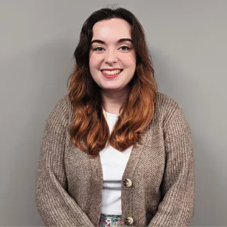 New employee Ellie smiling for the camera on her first day