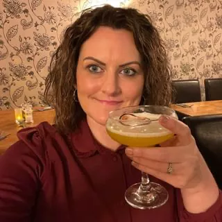 Michelle Schollar with cocktail in hand celebrating 16 years with HR2day